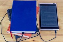 Stack of books plugged into an ereader 