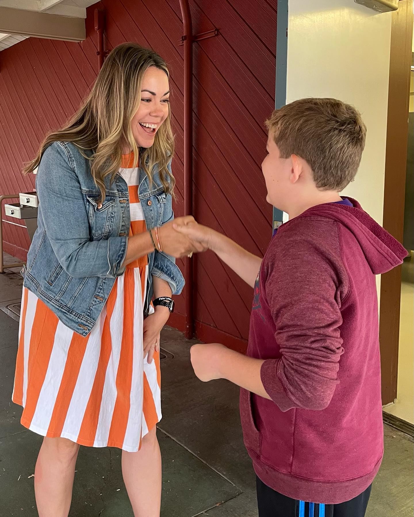 Principal Buschman and a student sharing the Valley Vista Handshake