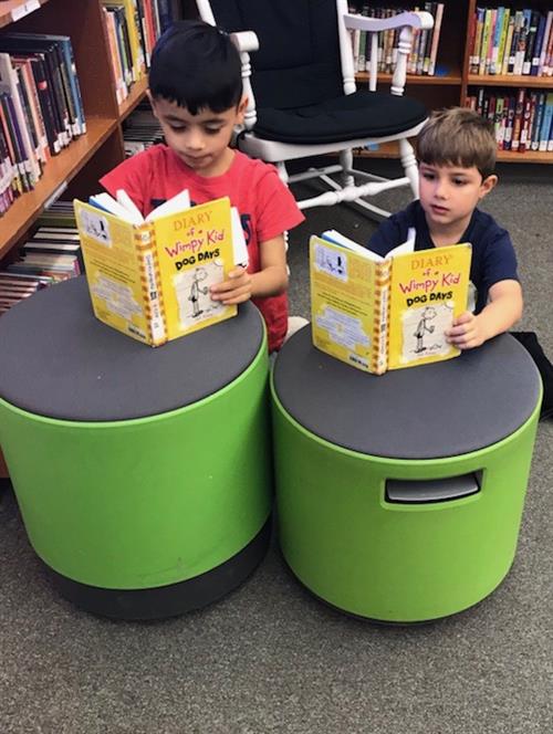 Two boys reading together 